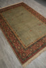 Load image into Gallery viewer, A rectangular area rug with a beige center field and a detailed red, green, and brown geometric border, shown on a gray wood-look floor.