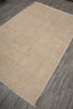 Load image into Gallery viewer, A rectangular area rug with a traditional floral pattern in beige and cream tones, laid out diagonally on a gray wood-look floor.