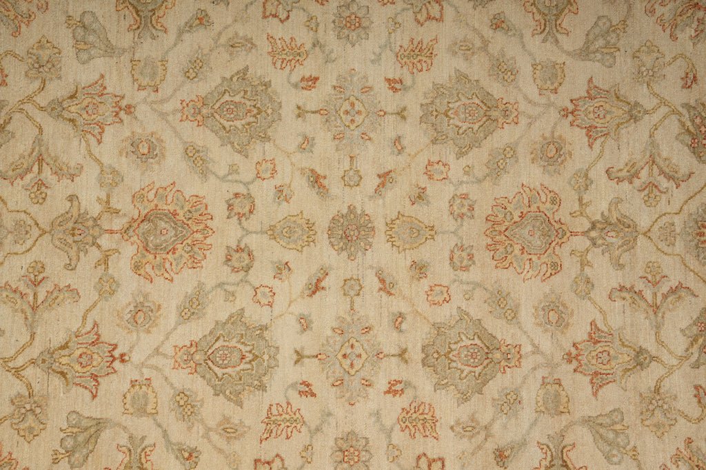 A close-up of a beige fabric or wallpaper pattern with an ornate floral and medallion design in muted gray, rust orange, and soft green tones.