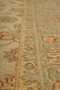 Load image into Gallery viewer, Close-up of a patterned area rug with a beige and gray base and muted red floral accents.