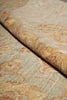 Load image into Gallery viewer, A close-up of patterned upholstery fabric with a rolled section showing the texture and color. The material has a muted sage green base with a warm beige and rust-orange floral damask pattern.