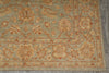 Load image into Gallery viewer, A close-up of a traditional patterned area rug with a muted sage green base, featuring warm beige and terracotta floral motifs and borders.
