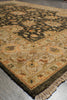 Load image into Gallery viewer, A traditional oriental area rug with an intricate floral and geometric pattern, shown laid out on a gray floor. The rug features a dark brown central field, a beige and orange border, and matching fringed edges.