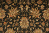 Load image into Gallery viewer, A close-up of a traditional patterned rug with a dark charcoal background and ornate floral motifs in beige, tan, muted orange, and brown.
