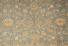 Load image into Gallery viewer, A close-up of a traditional patterned rug with a muted blue-gray background and warm beige floral motifs.