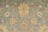 Load image into Gallery viewer, A close-up of a traditional patterned rug with a dusty blue-gray background and beige, tan, and muted gold floral motifs.