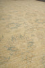 Load image into Gallery viewer, A close-up of a textured rug or fabric in a warm beige tone with faded gray and muted blue-gray distressed patterning.