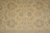 Load image into Gallery viewer, A close-up of a beige and muted blue-gray patterned rug or fabric with an ornate floral and scroll motif.