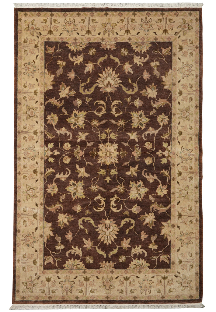A traditional rectangular area rug with a dark brown central field and a wide beige border, featuring an intricate floral and vine pattern throughout.