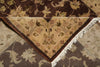 Load image into Gallery viewer, A close-up of a traditional patterned rug showing a corner with white fringe, featuring a beige center section with floral motifs and dark brown borders.