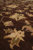 Load image into Gallery viewer, Close-up of a dark brown patterned rug with beige and muted green floral motifs.