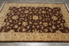 Load image into Gallery viewer, A rectangular area rug with an ornate floral and vine pattern, featuring a dark brown center field and beige borders, laid out on a gray tiled floor.
