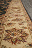Load image into Gallery viewer, A close-up view of an ornate area rug showing its detailed floral and medallion patterns in beige, brown, red, and green tones.