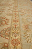 Load image into Gallery viewer, A close-up of a traditional patterned rug with a beige base and red, brown, and gray floral motifs.