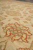 Load image into Gallery viewer, Close-up of a patterned area rug with a cream base and rust-orange floral motifs.