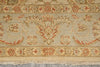 Load image into Gallery viewer, A close-up of a traditional patterned rug with a beige base, featuring red and brown floral motifs and a fringed edge.
