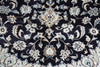 Load image into Gallery viewer, A close-up of an ornate traditional rug pattern with a dark navy blue background and cream, beige, and light blue floral and vine motifs.