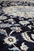 Load image into Gallery viewer, Close-up of a traditional patterned rug with a dark navy blue background and cream, beige, and light blue floral motifs.