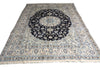 Load image into Gallery viewer, A traditional Persian-style area rug with a dark navy blue central medallion and intricate floral motifs in cream, beige, and light blue, shown flat against a white background.