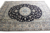 Load image into Gallery viewer, A traditional oriental area rug with a large central medallion, featuring a dark navy blue center surrounded by cream, beige, and light blue floral patterns and borders.