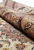 Load image into Gallery viewer, A close-up of a folded traditional patterned rug showing its detailed floral and geometric motifs in beige, cream, orange, and dark navy blue.