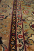 Load image into Gallery viewer, Close-up of a traditional patterned rug with floral motifs and ornate borders in beige, sage green, navy, red, and cream.
