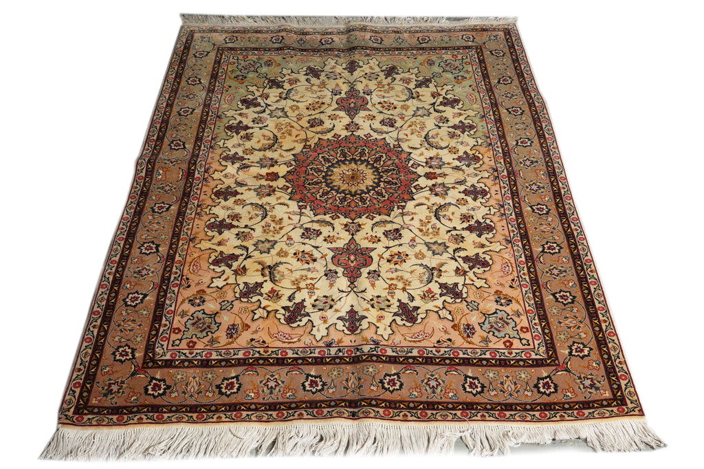 A traditional oriental area rug with a central medallion and floral motifs, featuring a warm beige field, brown and red borders, and off-white fringe on a white background.