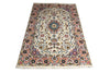 Load image into Gallery viewer, A rectangular traditional area rug with an intricate floral and medallion pattern, featuring a cream center, a dusty pink border, and multicolored accents including blue, green, and orange, shown against a plain white background.