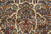 Load image into Gallery viewer, A close-up of an ornate floral patterned rug with a cream background and intricate motifs in blue, red, green, and orange.