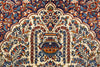 Load image into Gallery viewer, A close-up of an ornate traditional patterned rug featuring a central floral medallion and symmetrical scrolling motifs in cream, navy blue, rust red, and orange.