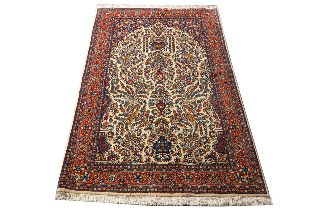A traditional oriental area rug with an intricate floral and geometric pattern, featuring a cream center, a dark red border, and blue accents, shown flat against a white background.