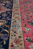 Load image into Gallery viewer, Close-up of a traditional patterned rug showing three distinct bands: a dark navy blue top section, a beige middle border with floral motifs, and a vibrant pink bottom section with blue and cream details.