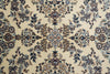 Load image into Gallery viewer, A close-up of an ornate floral patterned textile or rug with a cream background and detailed blue, brown, and muted gold motifs.