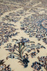 Load image into Gallery viewer, Close-up of an ornate floral patterned rug with cream background and blue, green, and brown embroidered motifs.