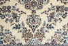 Load image into Gallery viewer, A close-up of an ornate traditional rug pattern with a cream background and detailed floral motifs in blue, brown, and black.
