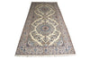 Load image into Gallery viewer, A long rectangular area rug with an intricate traditional Persian-style floral pattern, featuring cream, beige, blue, and brown tones, shown flat against a white background.
