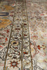 Load image into Gallery viewer, Close-up of an ornate patterned rug with cream, beige, red, blue, and yellow tones, showing detailed woven floral and geometric motifs.