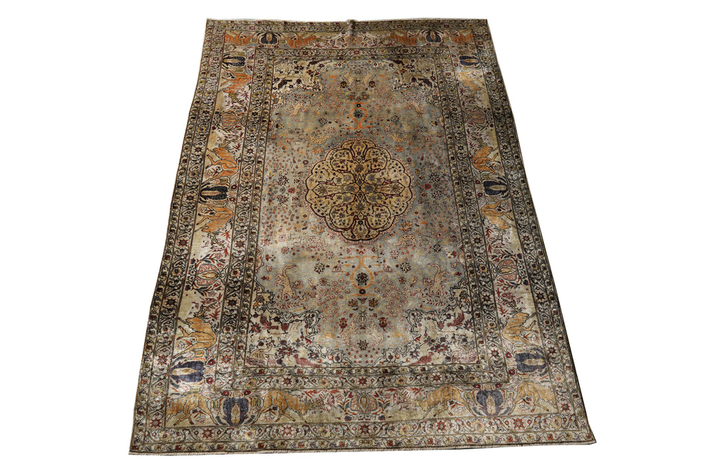 A traditional oriental area rug with a distressed, vintage pattern in muted tones of beige, brown, gray, and blue, shown flat against a white background.