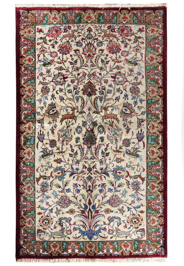 An ornate traditional Persian-style area rug with a cream-colored field, a central floral medallion, and a deep red border decorated with green, blue, and red floral motifs.