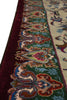 Load image into Gallery viewer, Close-up of an ornate patterned area rug showing a deep burgundy border, green field, and cream central section with detailed floral and paisley motifs in blue, red, and brown.