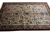 Load image into Gallery viewer, A rectangular Persian-style area rug with an intricate floral and vine pattern on a cream background, featuring a dark red border and teal accents.