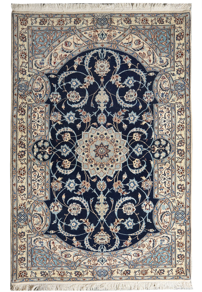 A traditional oriental-style area rug with a dark navy blue central field, cream and beige borders, and light blue floral details, shown flat against a white background.