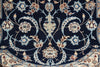 Load image into Gallery viewer, Close-up of an ornate traditional rug pattern with a dark navy blue field, cream and beige floral motifs, and light blue scrolling vine details.