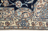 Load image into Gallery viewer, Close-up of a patterned area rug showing a navy blue field, cream borders, and intricate floral motifs in blue, brown, and beige.
