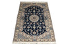 Load image into Gallery viewer, A traditional oriental-style area rug with a dark navy blue central field, intricate floral and vine motifs in beige, cream, and light blue, and a matching patterned border with white fringe on the top and bottom.