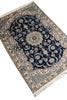 Load image into Gallery viewer, A traditional Persian-style area rug with a dark navy blue central field, intricate floral and vine motifs in beige, cream, and light blue, and a detailed border with cream fringe on the ends.
