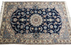 Load image into Gallery viewer, A traditional oriental area rug with a dark navy blue center field, cream borders, and intricate floral motifs in beige, light blue, and rust red.