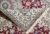 Load image into Gallery viewer, A close-up of a traditional patterned rug with cream, red, and blue floral motifs and fringed edges.