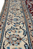 Load image into Gallery viewer, A close-up of a traditional patterned area rug with a cream base, featuring blue, brown, and red floral motifs and detailed borders.