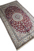 Load image into Gallery viewer, A traditional Persian-style area rug with an intricate floral pattern, featuring a deep red central field, cream borders, and blue accents, shown on a plain white background.